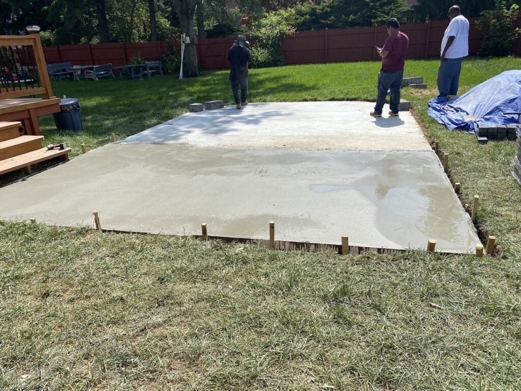 Concrete placement in progress in a framed exterior area