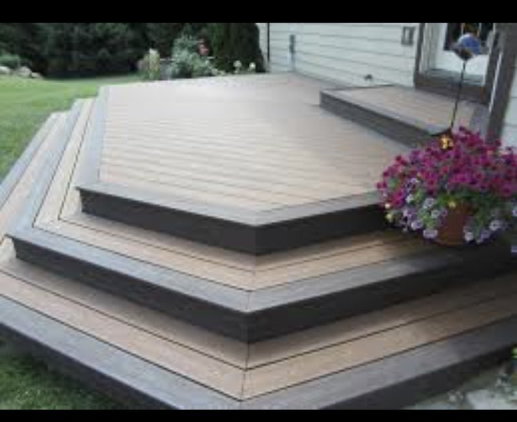 Deck with tiered steps beside a house