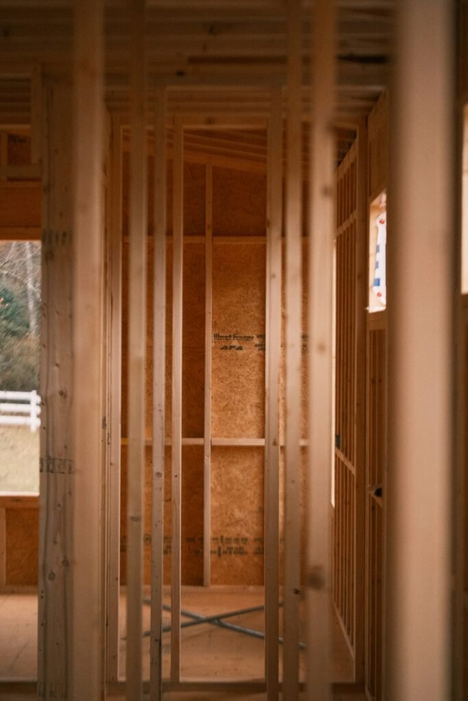Exposed wood wall framing inside a room under construction