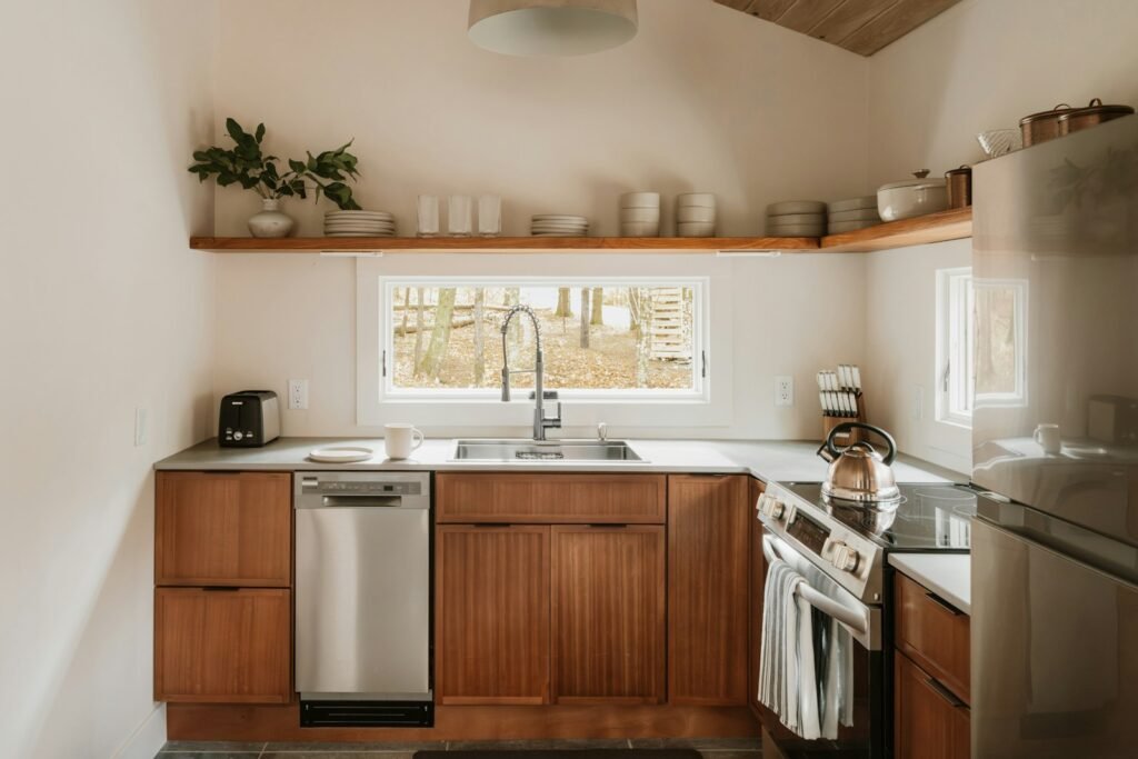 Kitchen with wood cabinets, white walls and stainless steel appliances