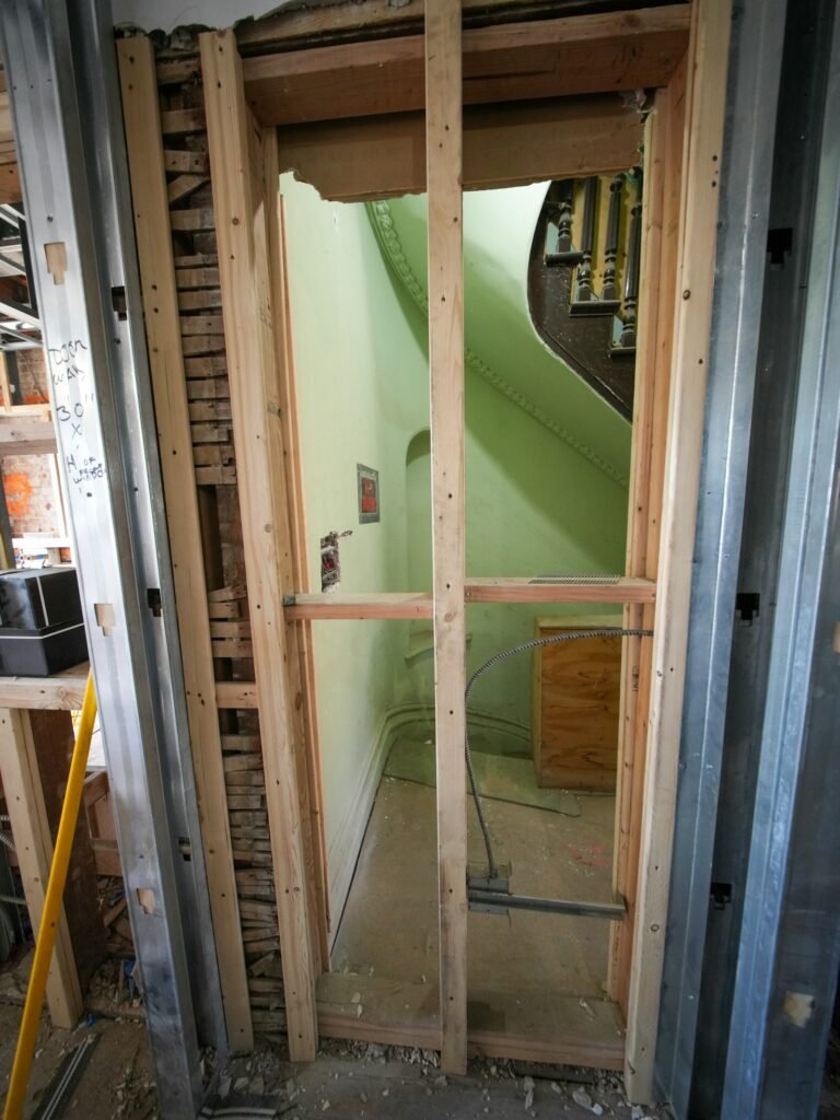 Exposed framing around a doorway in an unfinished interior
