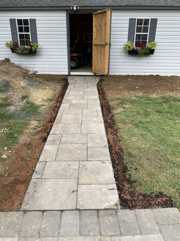 Paver walkway beside a house